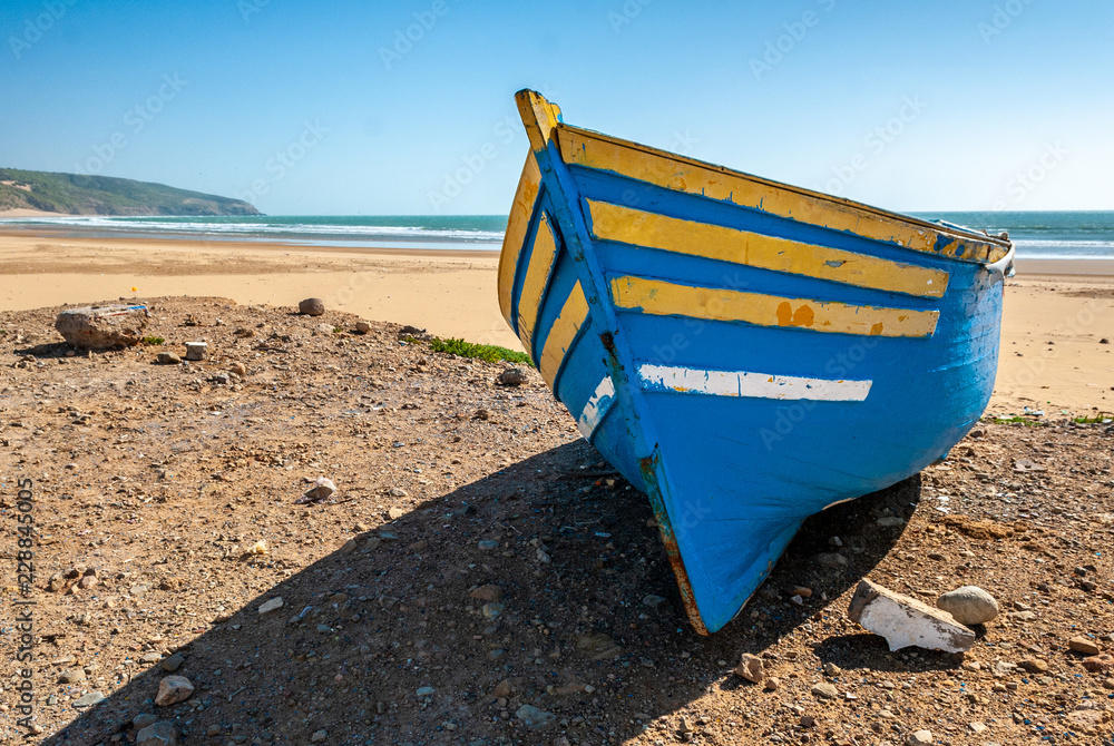 Fisherman's boat stranded on the beach of Tafelney, in the region of Essaouira in Morocco