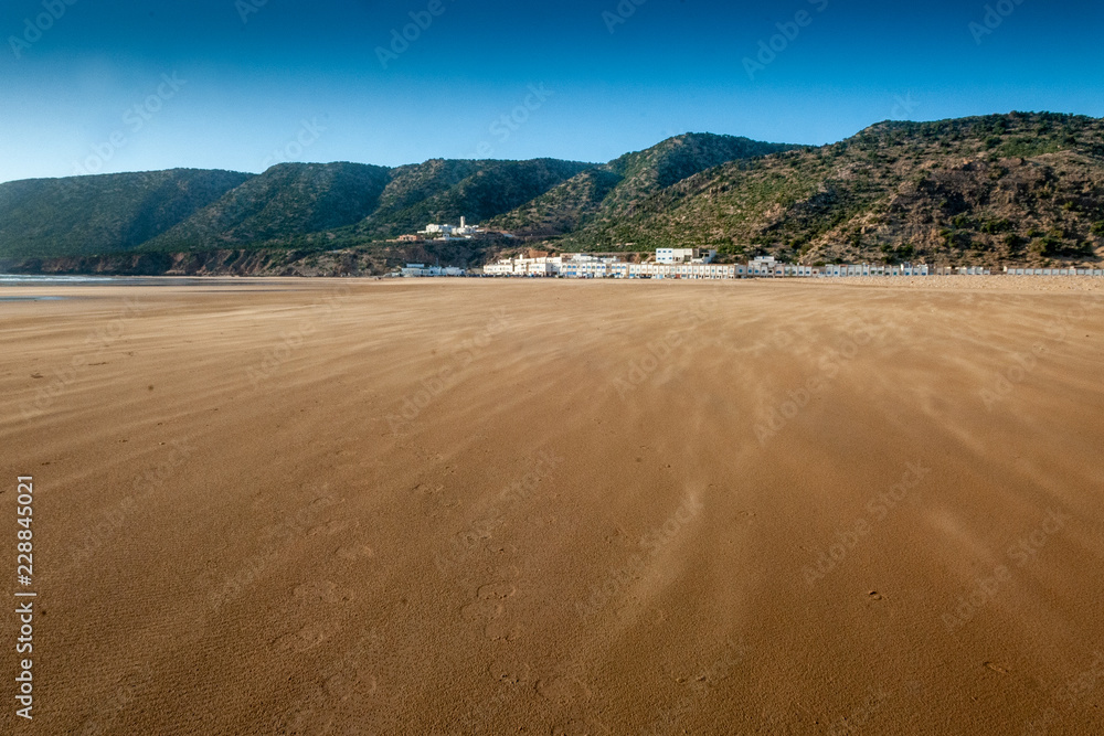 The wind makes the sand fly over the beach of Tafelney, in the area of Essaouira in Morocco The wind makes the sand fly over the beach of Tafelney, in the area of Essaouira in Morocco