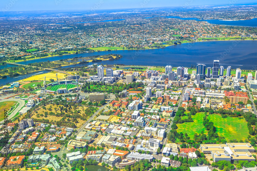 Aerial view of Perth Skyline and Heirisson Island in Australia. Scenic flight over the modern skyscrapers and Swan River in Western Australia.