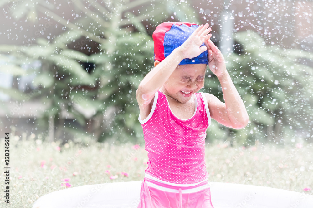 little girl playing in the swimming pool little girl playing in the swimming pool