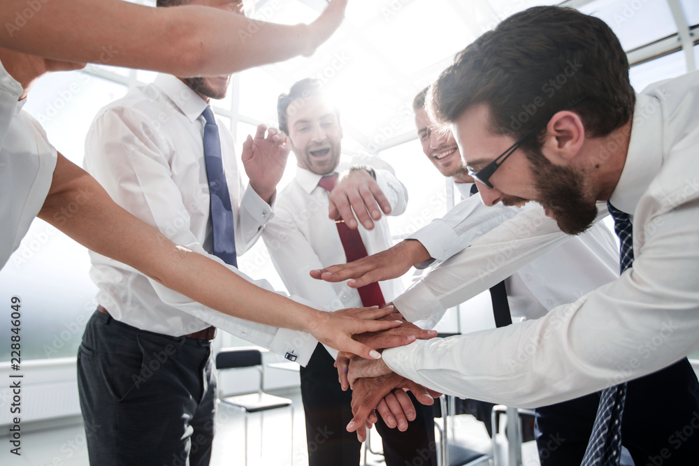 business team connects their hands together business team connects their hands together