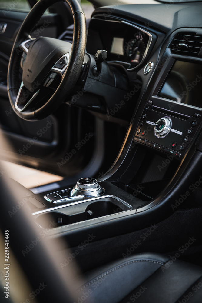 Luxurious car interior view through the open passengers door