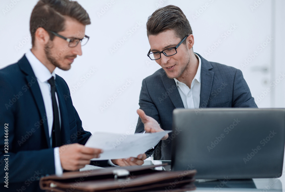 close up.two business men discussing a business document close up.two business men discussing a business document