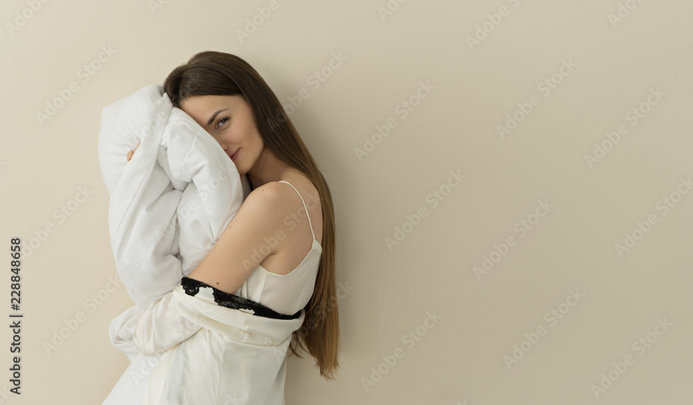 image of attractive smiling woman holding pillow , space for text image of attractive smiling woman holding pillow , space for text