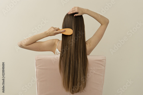 image of attractive woman brushing her long hair