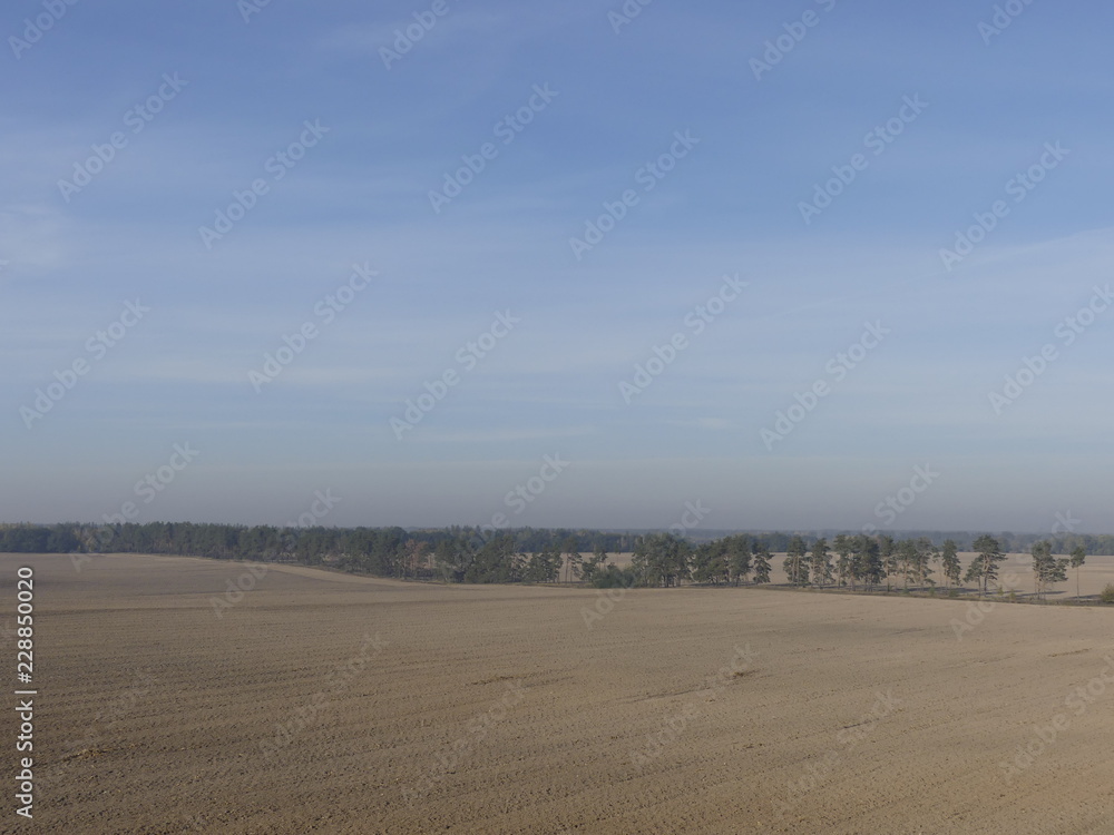 View of the empty plowed fields. Plowed field from a height of flight.