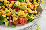 Sweet Corn salad with tomatoes, avocado, red onion, herbs and lime. close up