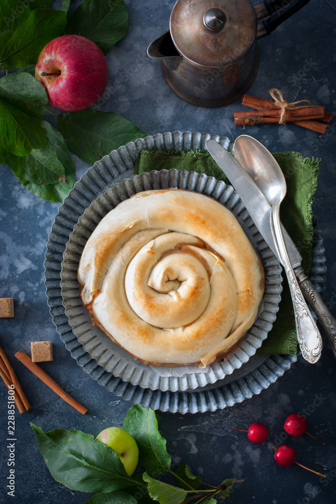 Vertuta, traditional Romanian, Moldavian or Balkan baking with apples . Rustic style, selective focus. Vertuta, traditional Romanian, Moldavian or Balkan baking with apples . Rustic style, selective focus.
