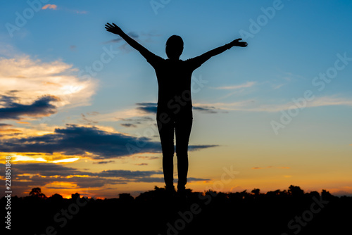 Young woman relaxing whit sunset sky outdoor.