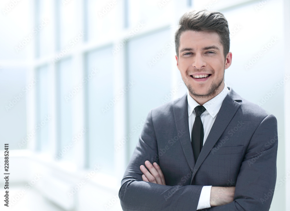 portrait of a businessman standing near the office window portrait of a businessman standing near the office window