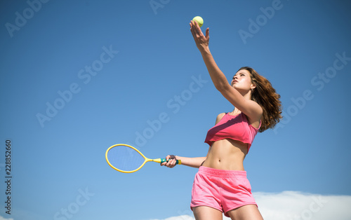 Girl with athletic body playing tennis. Happy active female workout. Beautiful attractive fitness woman. Sporty young woman. Tennis concept. © Volodymyr