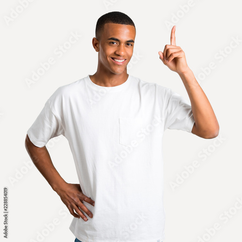 Young african american man showing and lifting a finger in sign of the best on isolated background
