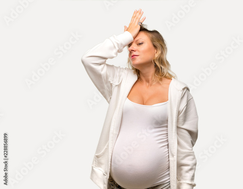Bild auf Leinwand Pregnant blonde woman with white sweatshirt intending to realizes the solution o