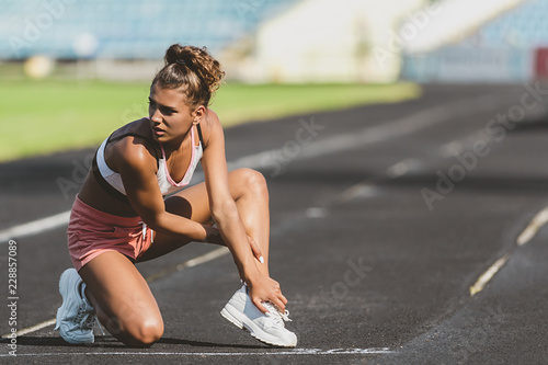 Sport woman getting hurt or injure on legs during outdoor running   jogging or marathon