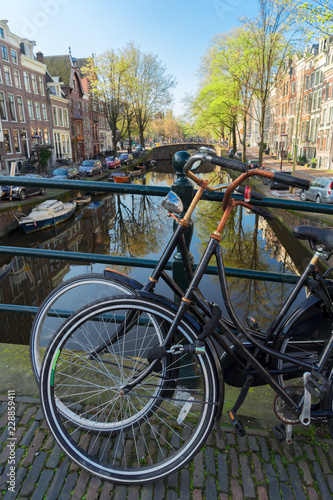 Romantic scenery with bicycles at one of the canals in Amsterdam old town, Netherlands