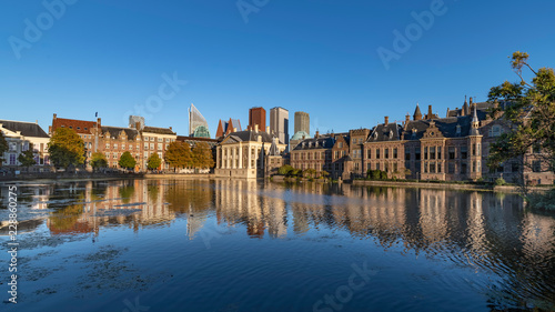 Reflection of the Buitenhof, Binnenhof buildings, Dutch parliament campus under a clear blue sky in The Hague, Netherlands