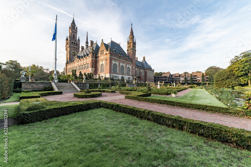 THE HAGUE, 26 September 2018 - Sunrise at the Peace Palace, seat of the International Court of Justice, view from the peaceful garden with flowers around the building