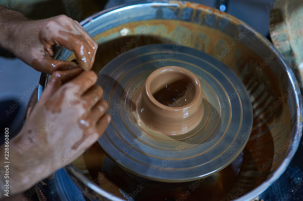 Fototapeta premium Master class on modeling of clay on a potter's wheel In the pottery workshop