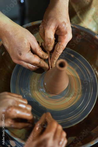 Master class on modeling of clay on a potter's wheel In the pottery workshop