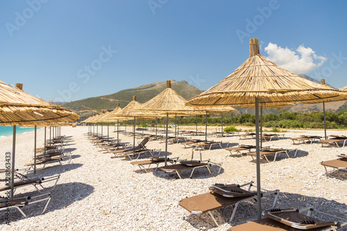 Umbrellas on the Borsh Beach in Albania. Stony beach on the Adriatic Sea.