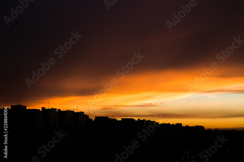 Orange sunset in the city. City landscape. Silhouette