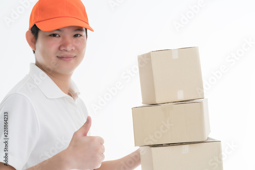 business casual asian delivery guy wear hat standing portrait hand hold  brown paper box with happiness and confident isolate white background © whyframeshot