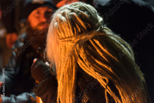 Girl with white dreadlocks at night, close-up