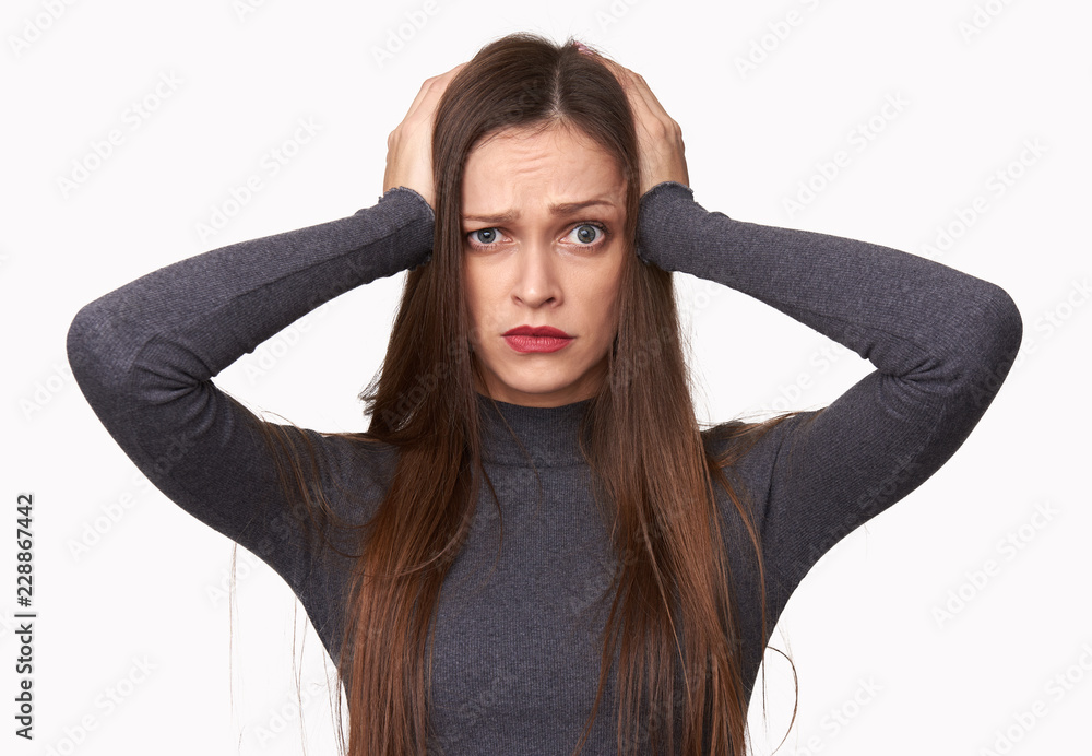 Shocked woman holds her hands on the head Shocked woman holds her hands on the head