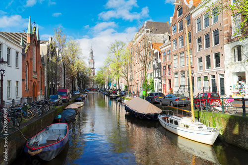 South Church Zuiderkerk and old Houses over canal with boats, Amsterdam, Netherlands