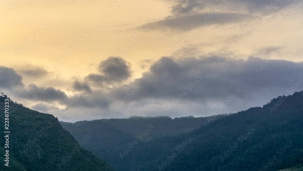 Clouds moving against the peak of Mount Kinabalu during the evening golden hour Clouds moving against the peak of Mount Kinabalu during the evening golden hour