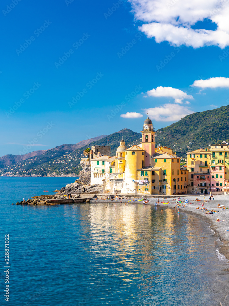 Scenic Mediterranean riviera coast. Panoramic view of Camogli town in Liguria, Italy. Basilica of Santa Maria Assunta and colorful palaces. Liguria, Italy