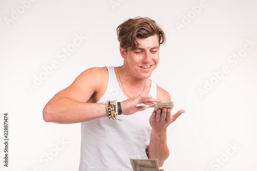 Concept of financial wealth, prosperity and lottery winnings - Man throwing away his money on white background