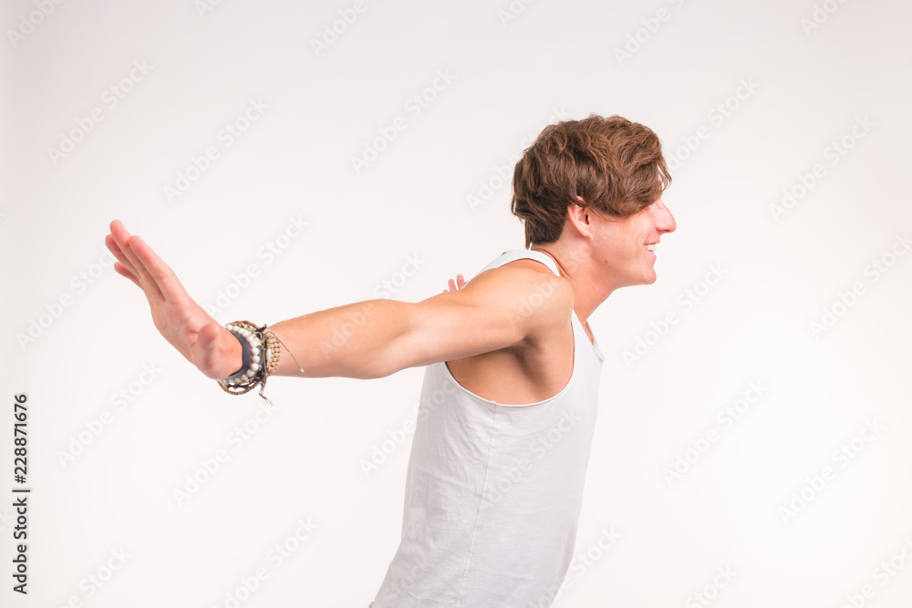 People and sport concept - young confident muscular man on white background People and sport concept - young confident muscular man on white background