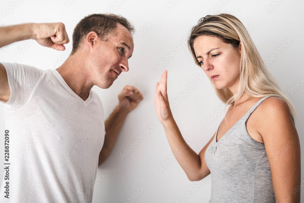 man beating helpless woman at home white background