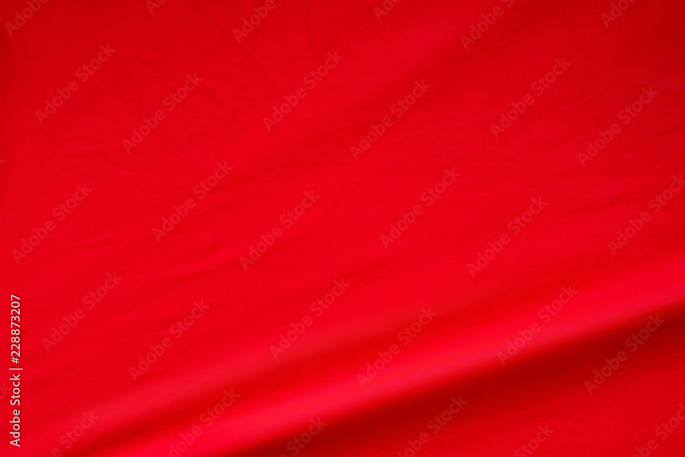 Red fabric background. Elegant vivid silk wave material texture. Red fabric background. Elegant vivid silk wave material texture.