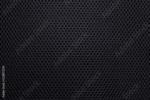 Black bumpy texture background. Abstract textile hole material or seat detail pattern.