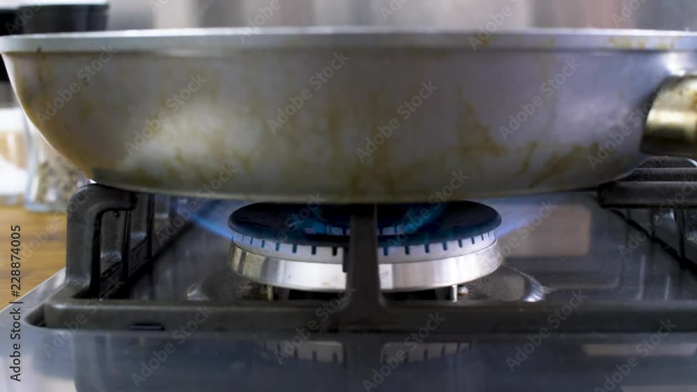 Gas stove with pan burning in slow motion