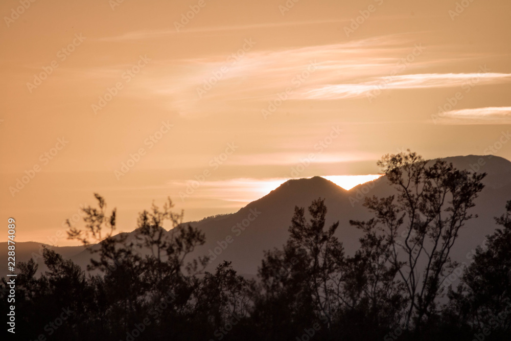 Sun Behind a Mountain