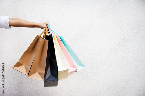 Shopping bags of women crazy shopaholic person at shopping mall.colorful paper shopping bags. photo