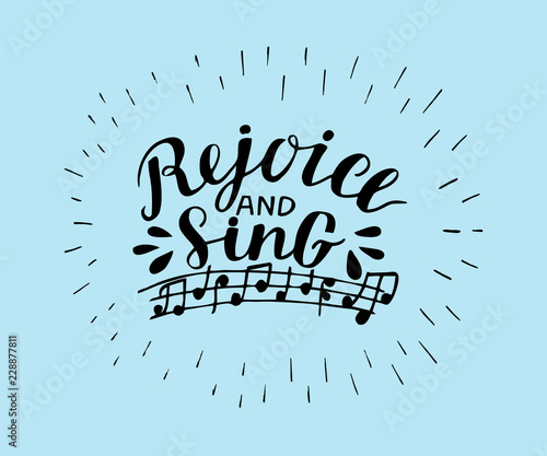 Hand lettering Rejoice and sing, made on blue background with notes. photo