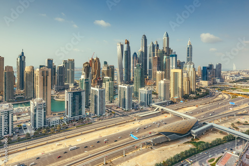 Aerial daytime skyline of Dubai Marina, UAE, with skyscrapers in the distance. Scenic travel background.