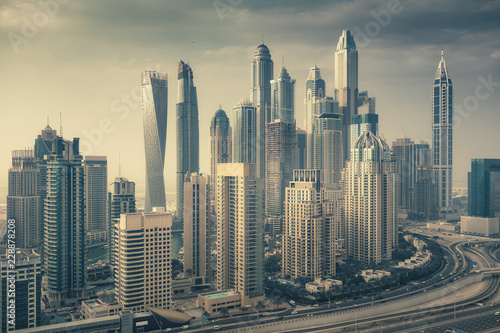Aerial daytime skyline of Dubai Marina, UAE, with skyscrapers in the distance. Scenic travel background.