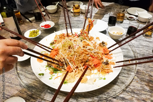 People tossing yee sang or yusheng during Chinese New Year photo