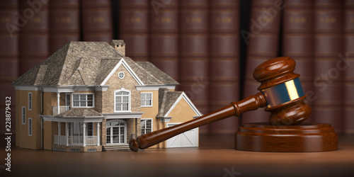 House with gavel and law books.  Real estate law and house auction concept