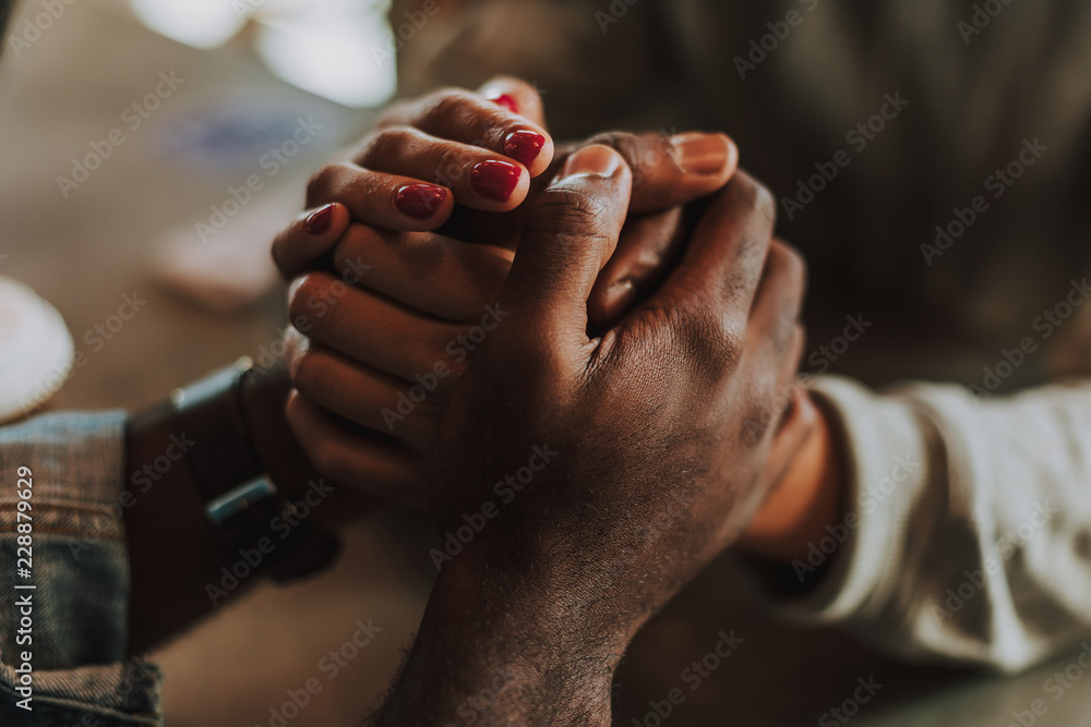 Holding hands. Laconic photo of young man and woman holding hands and looking cute - obrazy, fototapety, plakaty 