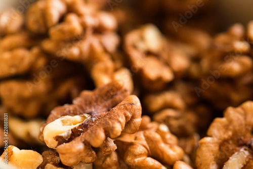 Background of unpeeled tasty walnuts close up