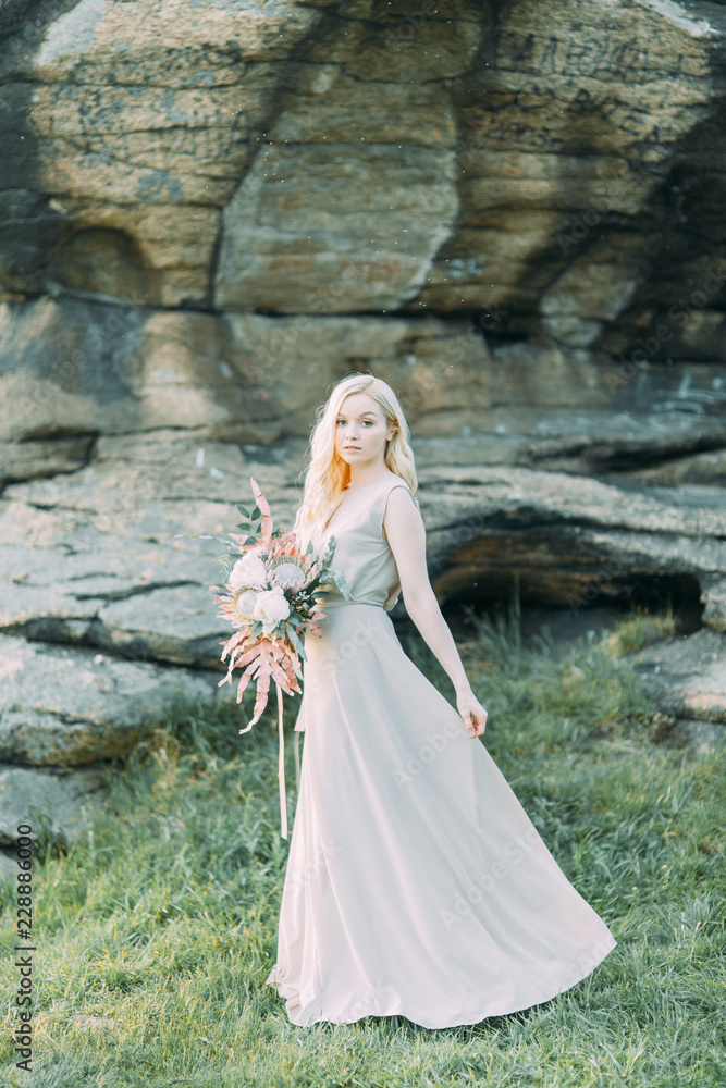 Bride in nature, in the mountains. Wedding in the style of fine art. The mountains and the sunset in the boudoir dress. Bride in nature, in the mountains. Wedding in the style of fine art. The mountains and the sunset in the boudoir dress.