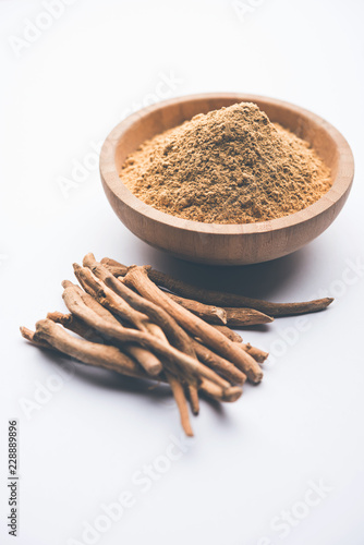 Ashwagandha / Aswaganda OR Indian Ginseng is an Ayurveda medicine in stem and powder form. Isolated on plain background. selective focus © Arundhati