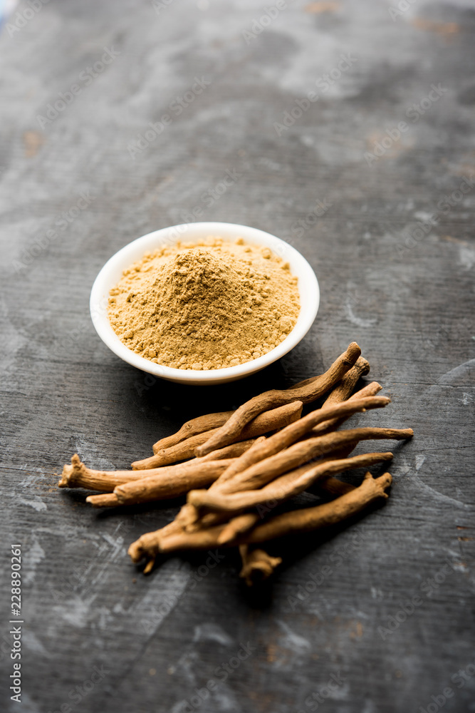 Ashwagandha / Aswaganda OR Indian Ginseng is an Ayurveda medicine in stem and powder form. Isolated on plain background. selective focus Ashwagandha / Aswaganda OR Indian Ginseng is an Ayurveda medicine in stem and powder form. Isolated on plain background. selective focus