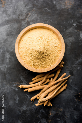 Ashwagandha / Aswaganda OR Indian Ginseng is an Ayurveda medicine in stem and powder form. Isolated on plain background. selective focus